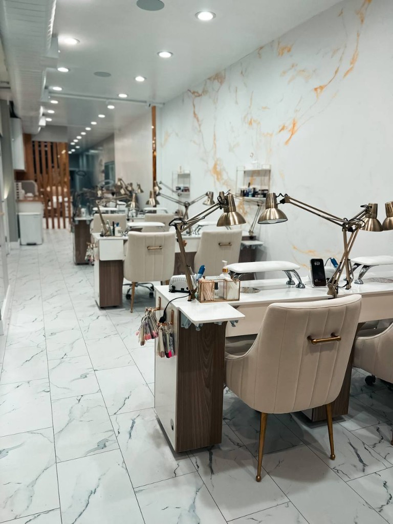 Manicure stations with marble walls at M. STUDIO NYC